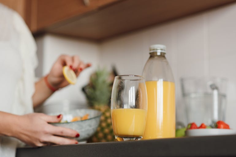 A person preparing fresh juice