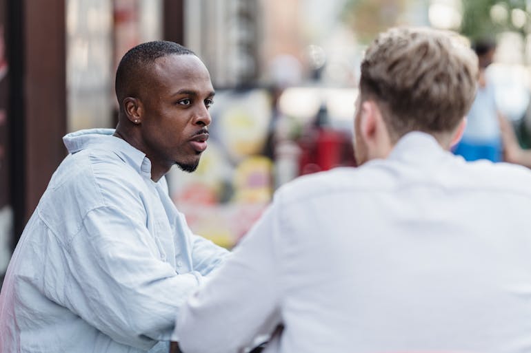 Two people talking about how to handle holiday stress and sobriety
