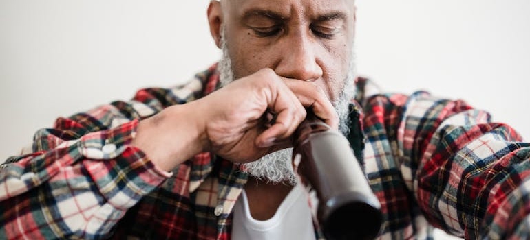 A person drinking a beer