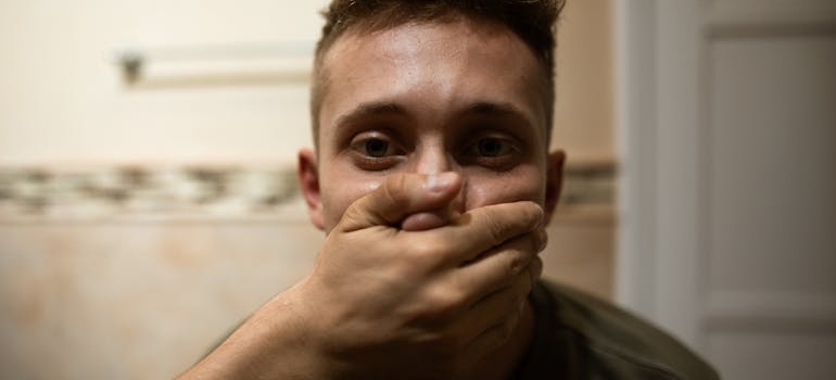 A man with covered mouth
